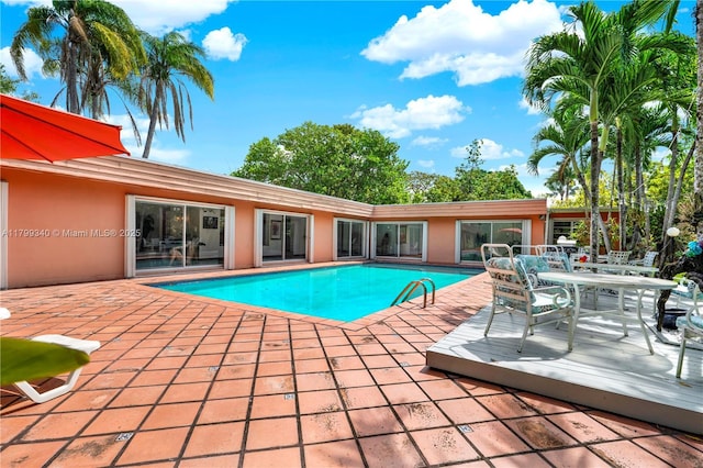 outdoor pool featuring a patio and outdoor dining area