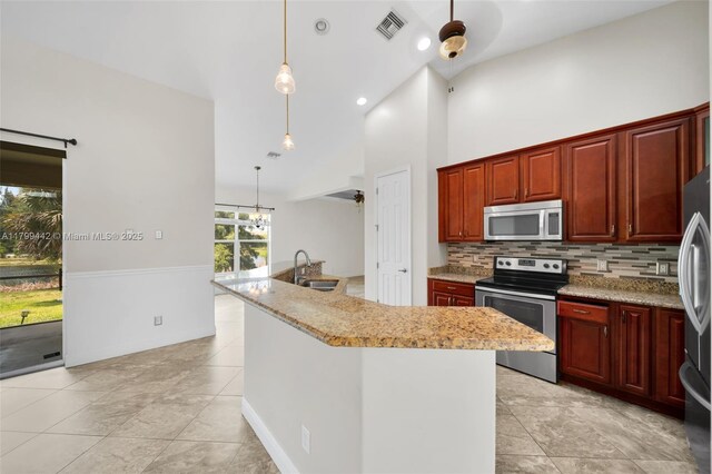 3326 SW 8th St, Cape Coral, FL 33991 - kitchen featuring appliances with stainless steel finishes, a sink, decorative backsplash, hanging light fixtures, and light tile patterned floors