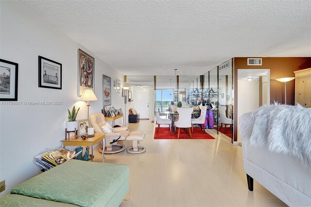 600 Three Islands Blvd Unit 1703, Hallandale Beach, FL 33009 - living area with a textured ceiling and wood finished floors