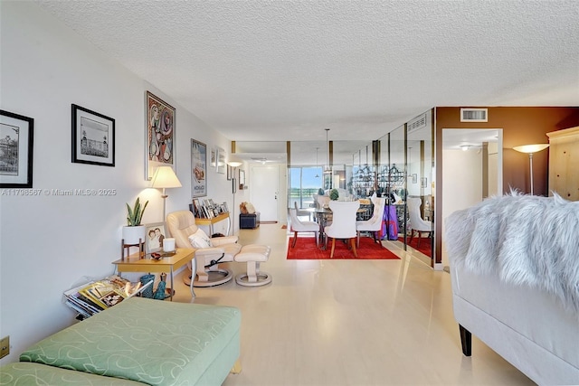 600 Three Islands Blvd Unit 1703, Hallandale Beach, FL 33009 - living room featuring a textured ceiling and wood finished floors