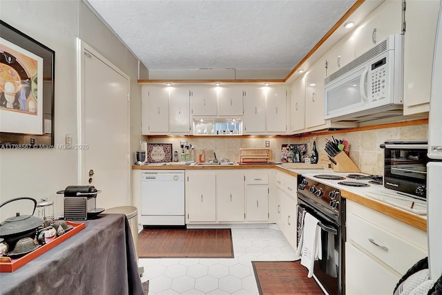 600 Three Islands Blvd Unit 1703, Hallandale Beach, FL 33009 - kitchen with white appliances, a sink, light tile patterned flooring, light countertops, and white cabinets