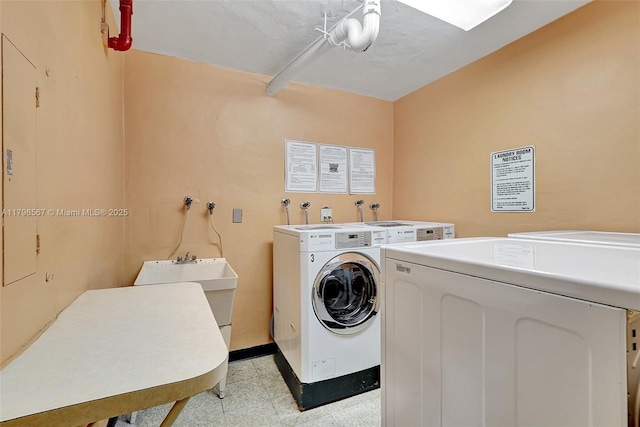 600 Three Islands Blvd Unit 1703, Hallandale Beach, FL 33009 - communal laundry room with washing machine and dryer and baseboards