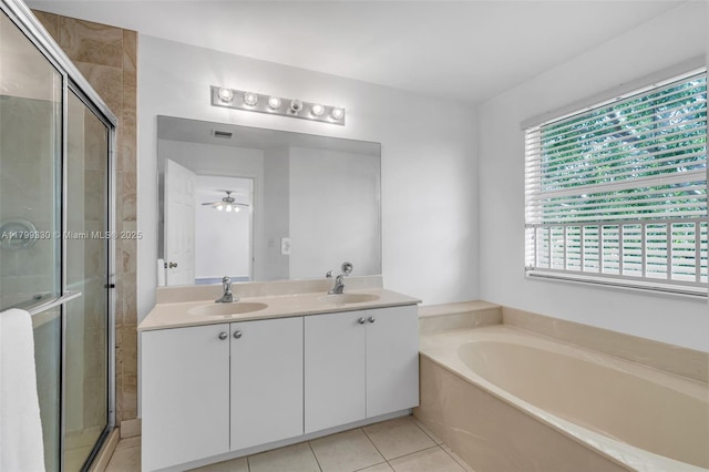 bathroom with a bath, a stall shower, double vanity, and tile patterned flooring