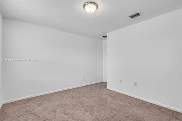 carpeted empty room with baseboards