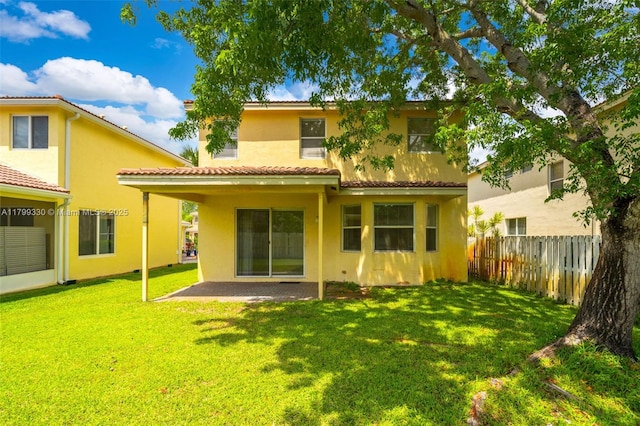 rear view of house featuring stucco siding and a patio area