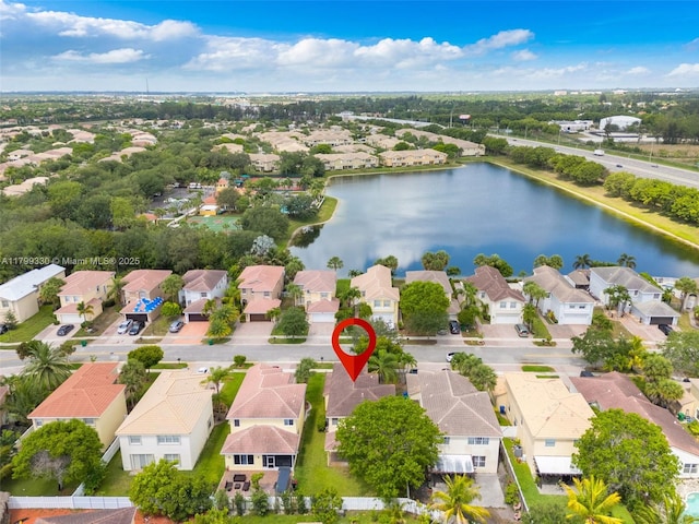 aerial perspective of suburban area with a nearby body of water