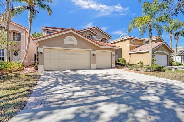 5354 NW 119th Ter, Coral Springs, FL 33076 - mediterranean / spanish-style house with stucco siding, driveway, an attached garage, and a tile roof