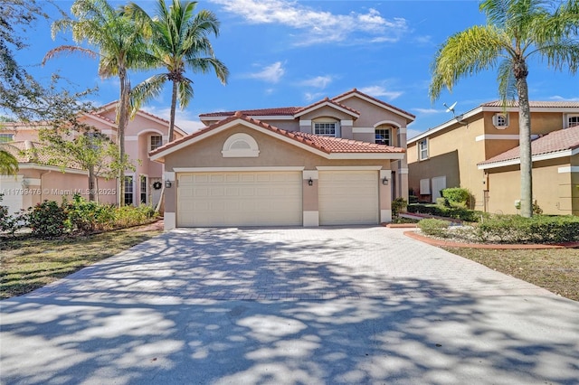 5354 NW 119th Ter, Coral Springs, FL 33076 - mediterranean / spanish home featuring stucco siding, decorative driveway, a tile roof, and an attached garage