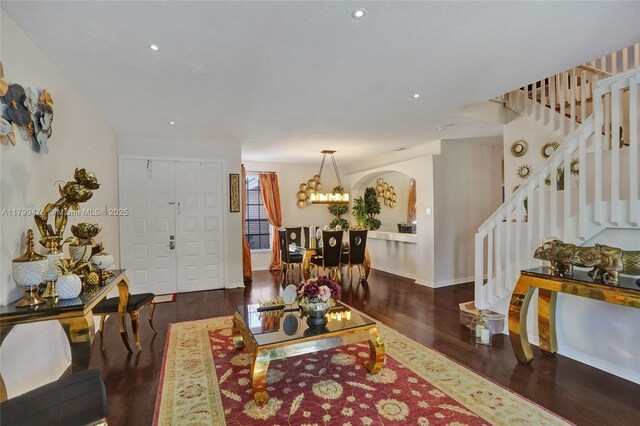 5354 NW 119th Ter, Coral Springs, FL 33076 - living area featuring wood finished floors, stairs, arched walkways, a chandelier, and recessed lighting