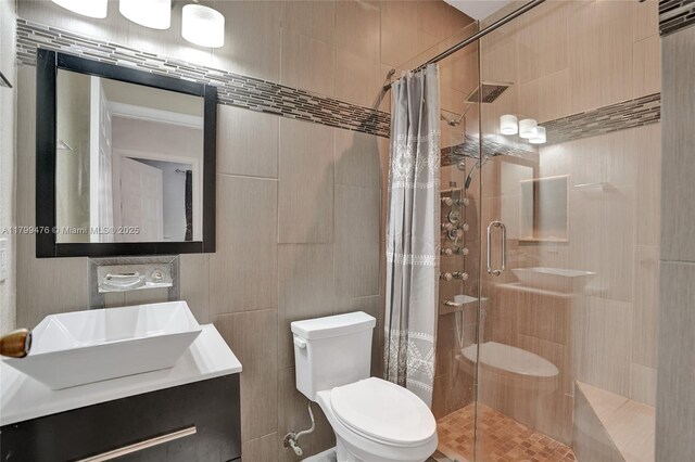 5354 NW 119th Ter, Coral Springs, FL 33076 - bathroom with a stall shower, tile walls, toilet, and a sink