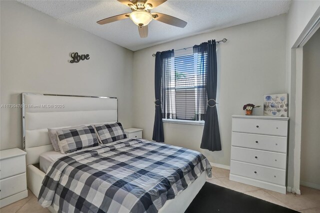 5354 NW 119th Ter, Coral Springs, FL 33076 - bedroom with light tile patterned floors, a textured ceiling, and ceiling fan