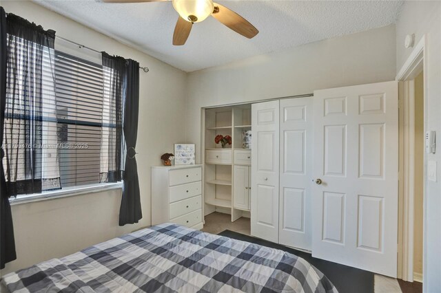 5354 NW 119th Ter, Coral Springs, FL 33076 - bedroom featuring multiple windows, a textured ceiling, a closet, and ceiling fan