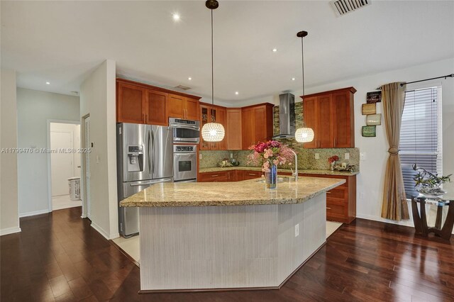 5354 NW 119th Ter, Coral Springs, FL 33076 - kitchen featuring stainless steel appliances, wall chimney exhaust hood, dark wood-type flooring, backsplash, and decorative light fixtures
