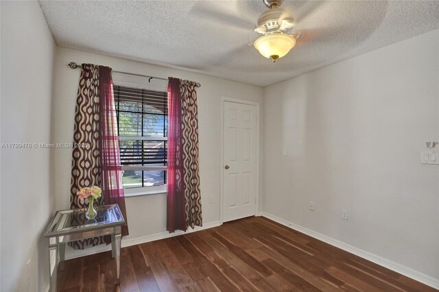 5354 NW 119th Ter, Coral Springs, FL 33076 - spare room with dark wood-style flooring, a textured ceiling, and baseboards