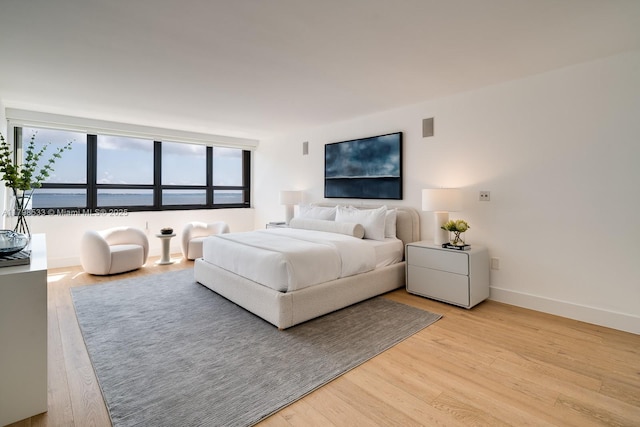 bedroom featuring light wood-style flooring and baseboards