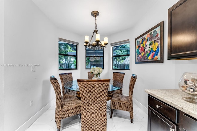 655 SE 37th Ter, Homestead, FL 33033 - dining space with a chandelier, baseboards, and light marble finish flooring