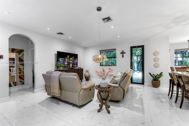 655 SE 37th Ter, Homestead, FL 33033 - living room with arched walkways, recessed lighting, light marble finish floors, and baseboards