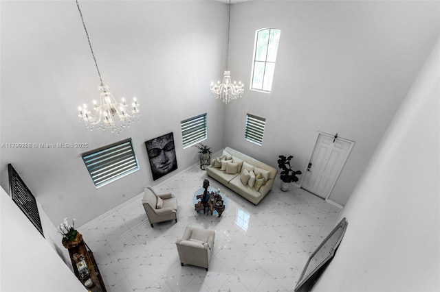 655 SE 37th Ter, Homestead, FL 33033 - unfurnished living room featuring a chandelier, a towering ceiling, and baseboards