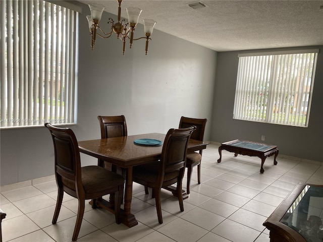 15456 NW 12th Pl, Pembroke Pines, FL 33028 - dining area with a chandelier, a textured ceiling, and light tile patterned floors