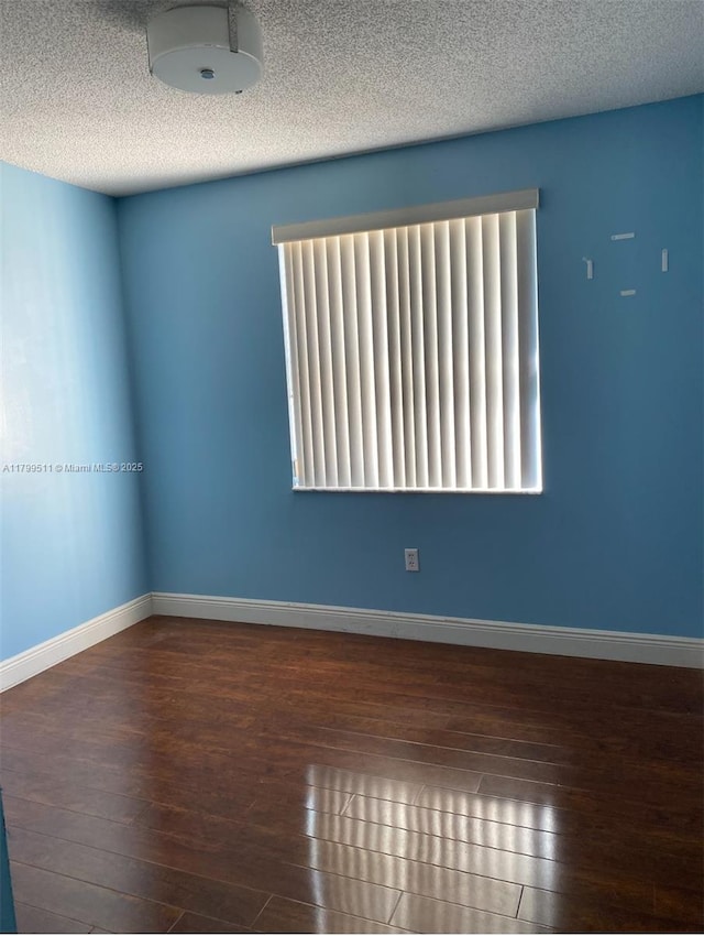 15456 NW 12th Pl, Pembroke Pines, FL 33028 - empty room with wood-type flooring, baseboards, and a textured ceiling