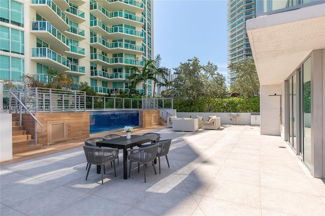 300 Sunny Isles Blvd Unit 4-501, Sunny Isles Beach, FL 33160 - view of patio / terrace with an outdoor living space, stairway, and outdoor dining area