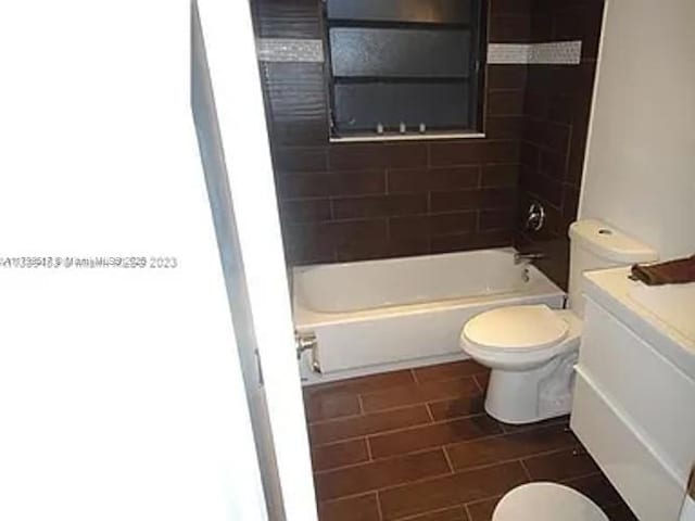 3361 NW 85th Ave Unit 201, Coral Springs, FL 33065 - bathroom with toilet, tile patterned flooring, shower / tub combination, and vanity