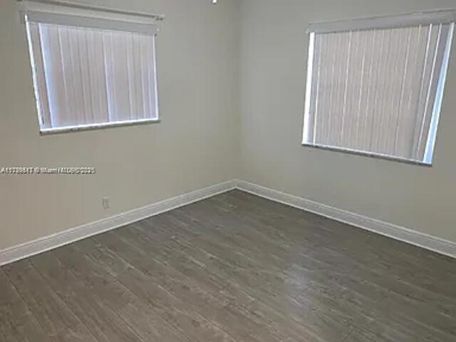 3361 NW 85th Ave Unit 201, Coral Springs, FL 33065 - unfurnished room with baseboards and dark wood finished floors
