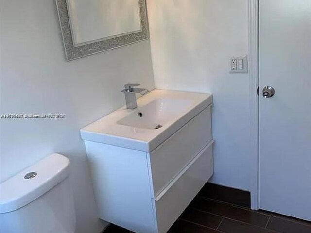 3361 NW 85th Ave Unit 201, Coral Springs, FL 33065 - bathroom with vanity, toilet, and tile patterned flooring