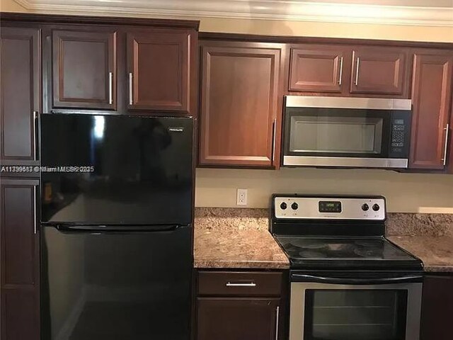 3361 NW 85th Ave Unit 201, Coral Springs, FL 33065 - kitchen featuring appliances with stainless steel finishes and light stone countertops