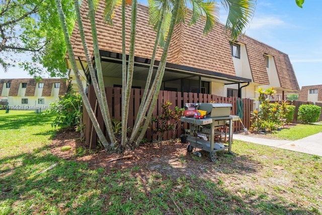 216 San Remo Blvd, North Lauderdale, FL 33068 - rear view of house featuring mansard roof and a shingled roof