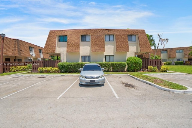 216 San Remo Blvd, North Lauderdale, FL 33068 - view of building exterior with uncovered parking and fence
