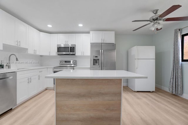 216 San Remo Blvd, North Lauderdale, FL 33068 - kitchen featuring stainless steel appliances, a sink, light wood-style flooring, recessed lighting, and light countertops