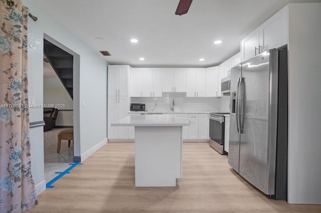 216 San Remo Blvd, North Lauderdale, FL 33068 - kitchen featuring stainless steel appliances, a sink, light wood-type flooring, light countertops, and white cabinets
