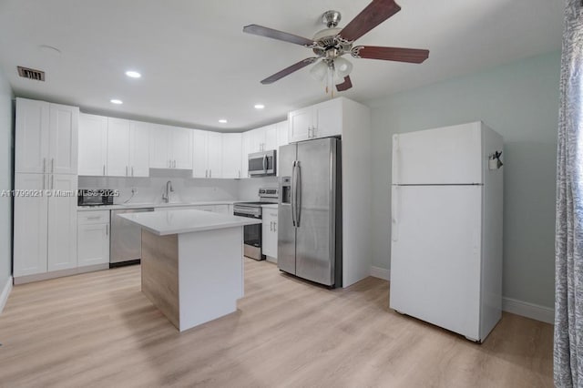 216 San Remo Blvd, North Lauderdale, FL 33068 - kitchen featuring stainless steel appliances, ceiling fan, a center island, light wood-style flooring, and light countertops