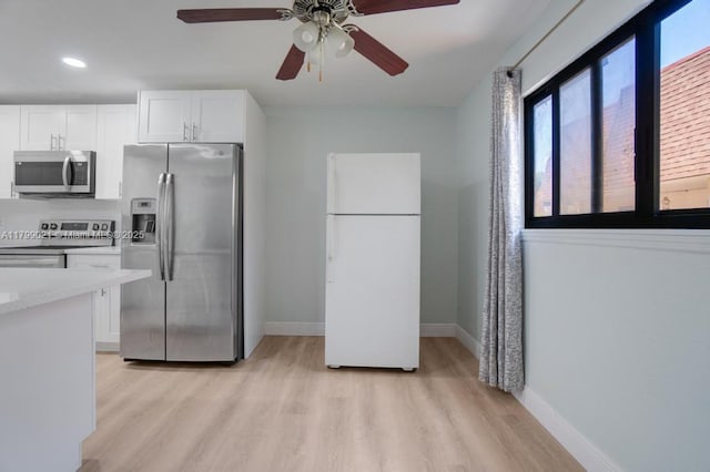 216 San Remo Blvd, North Lauderdale, FL 33068 - kitchen featuring appliances with stainless steel finishes, light wood-style flooring, white cabinets, a ceiling fan, and recessed lighting