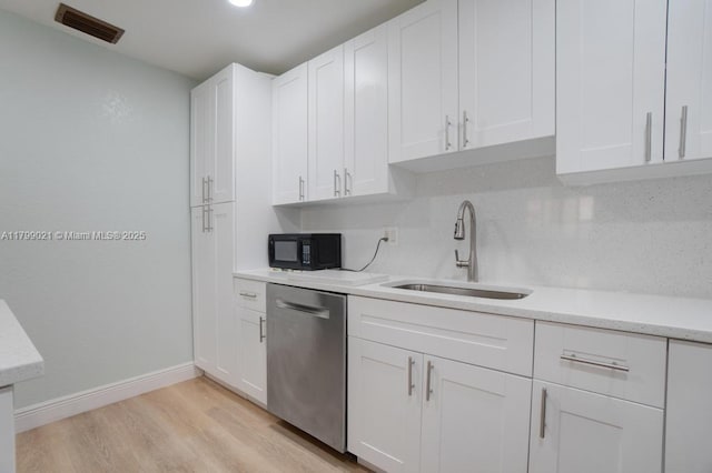 216 San Remo Blvd, North Lauderdale, FL 33068 - kitchen with dishwasher, a sink, white cabinetry, light wood finished floors, and black microwave