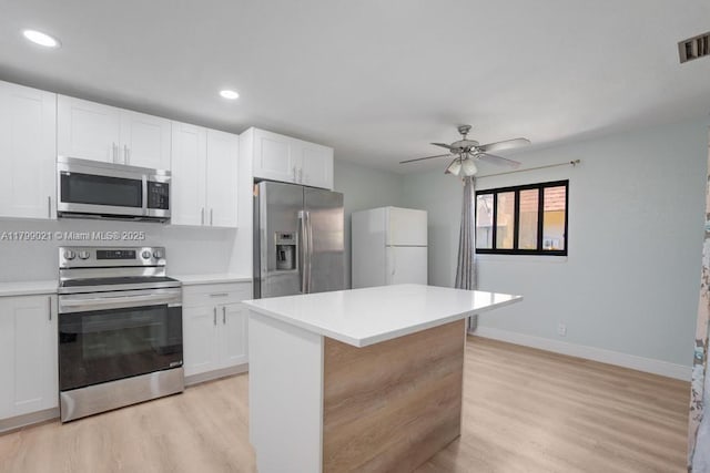 216 San Remo Blvd, North Lauderdale, FL 33068 - kitchen with stainless steel appliances, light wood-style floors, light countertops, white cabinetry, and recessed lighting