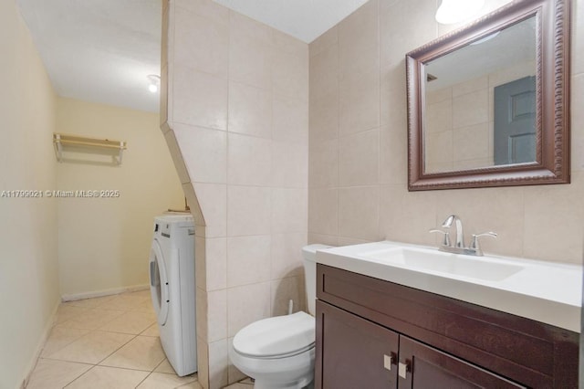 216 San Remo Blvd, North Lauderdale, FL 33068 - bathroom featuring washer / clothes dryer, tile walls, vanity, toilet, and tile patterned floors