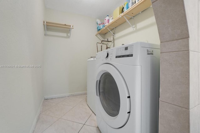216 San Remo Blvd, North Lauderdale, FL 33068 - laundry room with washer / dryer, light tile patterned floors, and baseboards