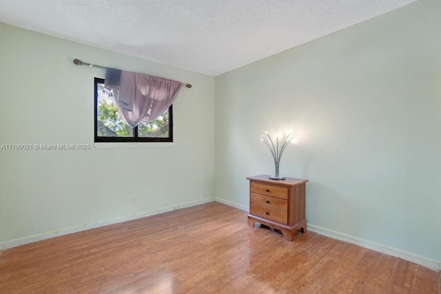 216 San Remo Blvd, North Lauderdale, FL 33068 - unfurnished room with light wood-style floors, baseboards, and a textured ceiling