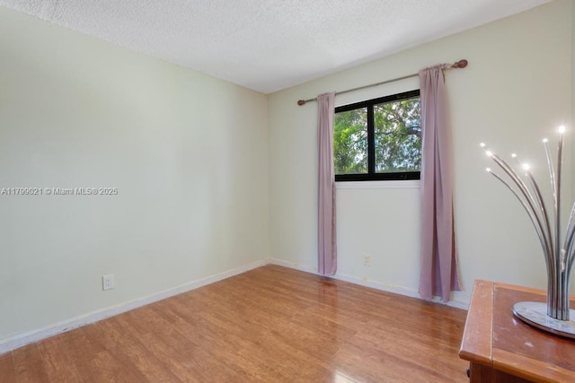 216 San Remo Blvd, North Lauderdale, FL 33068 - spare room featuring light wood-style flooring, a textured ceiling, and baseboards