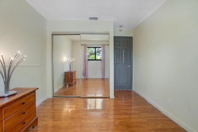 216 San Remo Blvd, North Lauderdale, FL 33068 - hallway with light wood finished floors, baseboards, and a textured ceiling