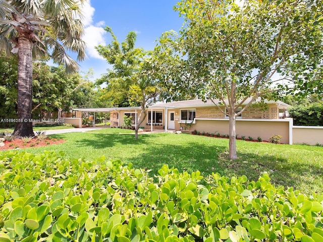 10643 NE 10th Pl, Miami Shores, FL 33138 - view of yard with a carport