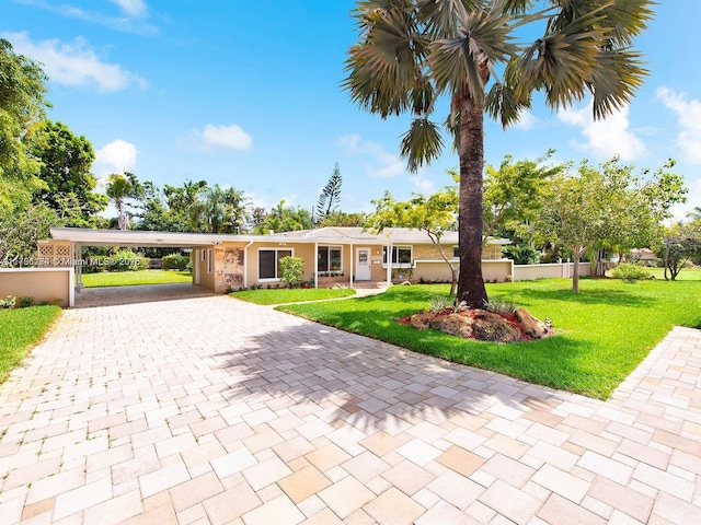 10643 NE 10th Pl, Miami Shores, FL 33138 - ranch-style home with decorative driveway and an attached carport