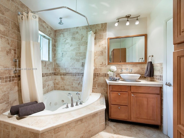 10643 NE 10th Pl, Miami Shores, FL 33138 - bathroom with a combined bath / shower with jetted tub, vanity, and tile walls