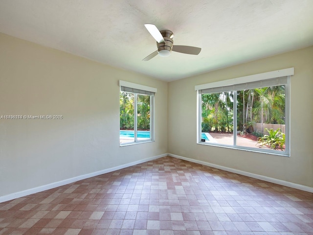 10643 NE 10th Pl, Miami Shores, FL 33138 - spare room featuring baseboards and ceiling fan