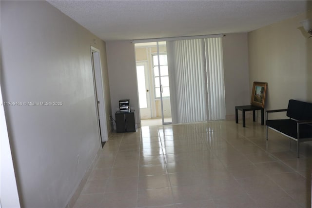 7891 N Sunrise Lakes Dr Unit 101, Sunrise, FL 33322 - unfurnished room featuring tile patterned floors and a textured ceiling