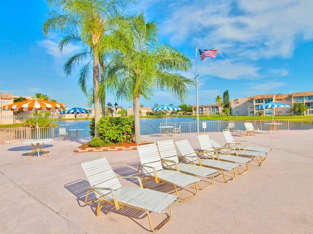 7891 N Sunrise Lakes Dr Unit 101, Sunrise, FL 33322 - view of patio featuring a residential view, a water view, and fence