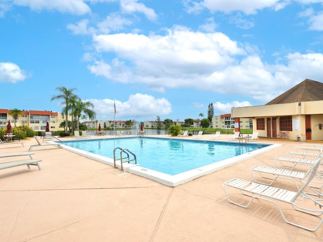 7891 N Sunrise Lakes Dr Unit 101, Sunrise, FL 33322 - community pool featuring a patio area