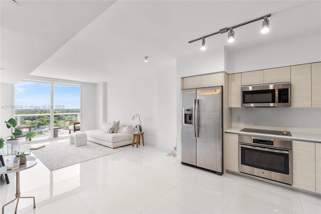 4250 Biscayne Blvd Unit 1112, Miami, FL 33137 - kitchen featuring appliances with stainless steel finishes, modern cabinets, light countertops, floor to ceiling windows, and open floor plan